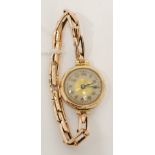 LADY'S 9ct GOLD WRISTWATCH with mechanical movement, arabic dial and the 9ct gold expanding