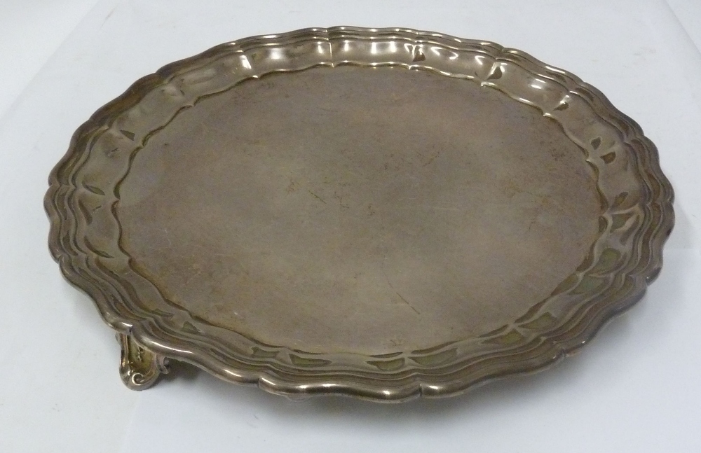 SILVER WAITER WITH RAISED SCALLOPED BORDER, standing on three scroll moulded tab feet, Sheffield