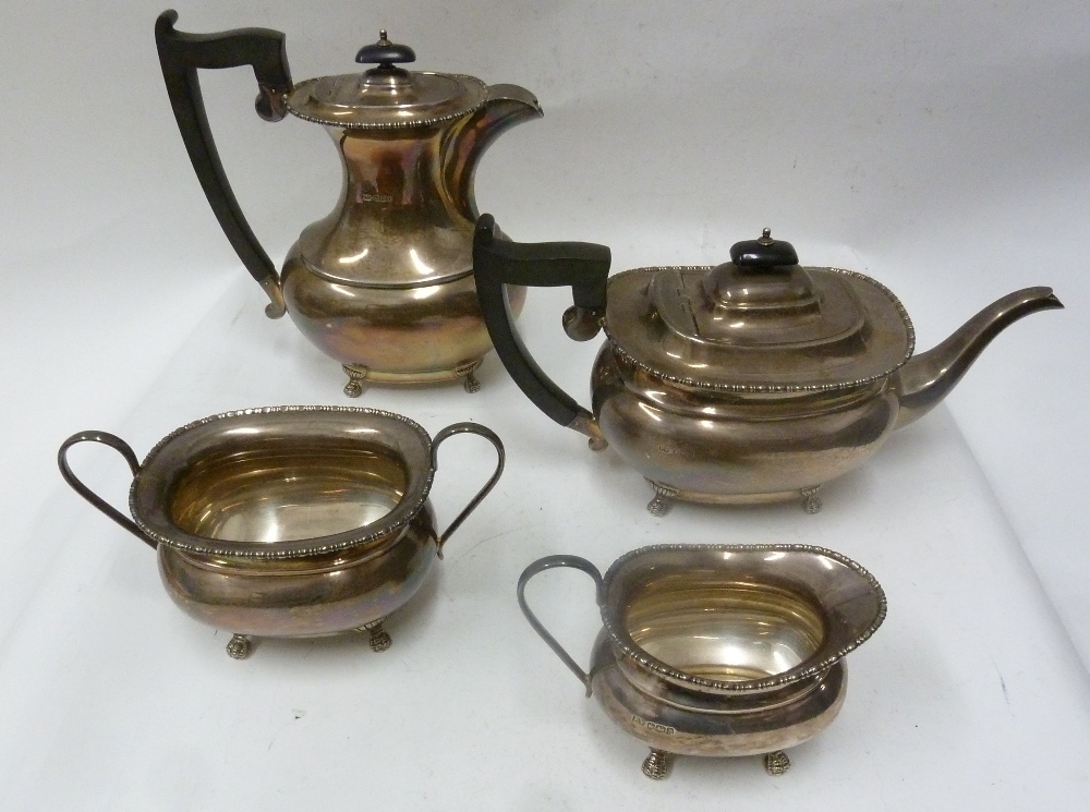 FOUR PIECE SILVER TEA AND COFFEE SERVICE of rounded oblong form with beaded rims, blackwood