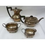 FOUR PIECE SILVER TEA AND COFFEE SERVICE of rounded oblong form with beaded rims, blackwood