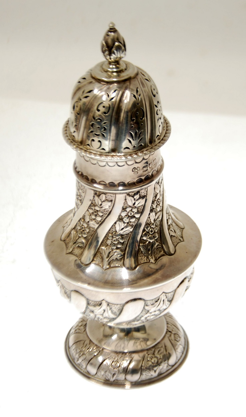 EDWARD VII EMBOSSED SILVER PEDESTAL CASTOR by Charles Boyton and Son, wrythen fluted with floral