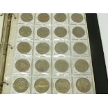 A RED COIN ALBUM CONTAINING APPROX 174 WORLD COINS, Elizabeth II UK and Isle of Man crowns mainly