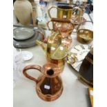 A COPPER KETTLE, AN OLD COPPER CONICAL JUG, A COPPER AND BRASS TOILET JUG AND A COPPER AND BRASS