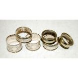 TWO PAIRS OF GEORGE V FLORAL ENGRAVED SILVER NAPKIN RINGS, Birmingham 1921 and 1923, 1.5oz and a