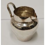 SILVER COLOURED METAL CREAM JUG, the ovular body having lightly engraved festoon border, 'C'