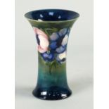 WILLIAM MOORCROFT TUBE LINED POTTERY VASE, in the Anemone design, of waisted form, painted in