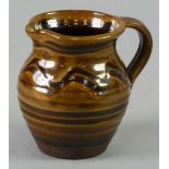 MICHAEL CARDEW STYLE STUDIO POTTERY JUG, of ovoid form with loop handle, slip trailed in brown