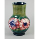 WALTER MOORCROFT TUBE LINED POTTERY VASE, in the Anemone design, of footed baluster form with