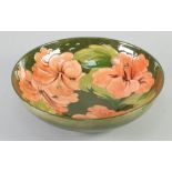 WALTER MOORCROFT 'HIBISCUS' DESIGN TUBE LINED POTTERY FRUIT BOWL, of shallow, footed form, painted