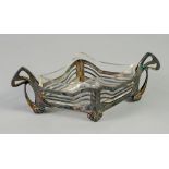 A GERMAN ART NOUVEAU SILVER PLATED WHITE METAL LOZENGE SHAPE DISH, with leaf glass liner, the