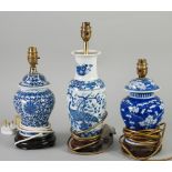 THREE CHINESE BLUE AND WHITE TABLE LAMPS, two of vase and cover form, the other of Indian club