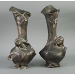 A PAIR OF CONTINENTAL ART NOUVEAU SILVERED WHITE METAL VASES, cast in relief with female heads