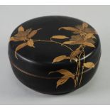 JAPANESE LATE MEIJI PERIOD BLACK LACQUERED AND GILT BOX AND COVER, circular form, the cover