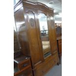 A CARVED OAK WARDROBE WITH MIRROR DOOR AND DRAWER BELOW, 4' WIDE