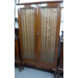 A MAHOGANY BOOKCASE WITH TWO GLAZED DOORS, INTERIOR WITH ADJUSTABLE SHELVES, RAISED ON CABRIOLE