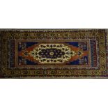 MODERN TURKEY WOOL PILE RUG of vibrant Persian design, the centre field with medallion within wide