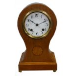 EDWARDIAN INLAID OAK MANTEL CLOCK in balloon shaped case, the 4" Arabic dial powered by an 'Ansonia'