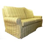 A MULTIYORK THREE SEATER SETTEE, COVERED IN CREAM AND GREEN STRIPED FABRIC (purchased 03/04/2012)