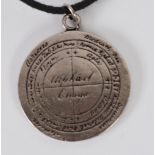 AN OLD SILVER COLOURED METAL AMULET OR RELIGIOUS TALISMAN, with Latin inscription, referring to