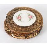 EARLY TWENTIETH CENTURY GILT METAL CIRCULAR POWDER COMPACT, the hinged lid, white guilloche
