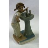 A LLADRO FIGURE, YOUNG GIRL STOOD AT A SINK, 7 1/2" HIGH