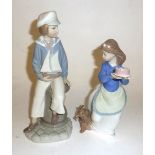 LLADRO SPANISH PORCELAIN BOY WITH MODEL YACHT AND A NAO FIGURE OF A GIRL CARRYING A CAKE WITH DOG AT