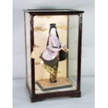 A 1950's JAPANESE RICHLY COIFFURED AND DRESSED GEISHA DOLL, contained in a lacquered wooden framed