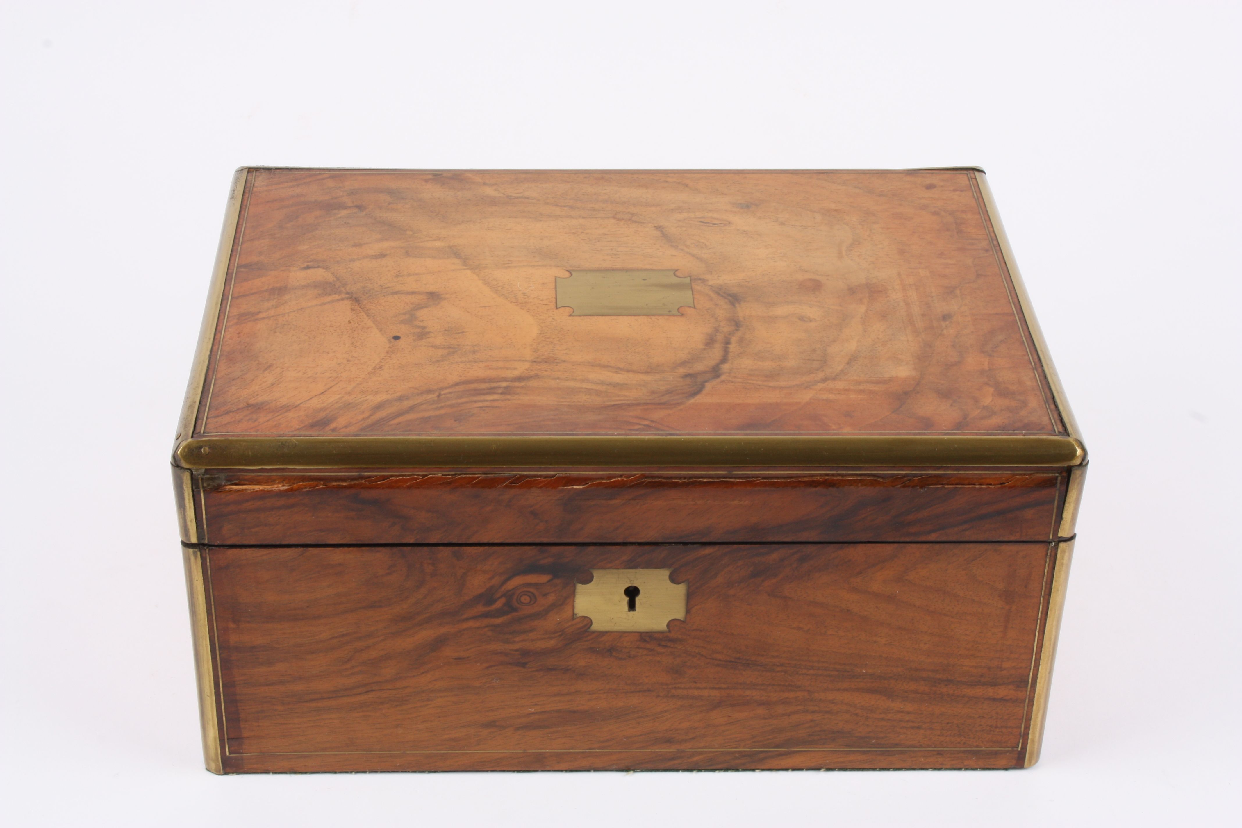 A Victorian figured walnut writing box
with brass bound edges and cartouche, and fitted interior.,