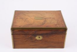 A Victorian figured walnut writing boxwith brass bound edges and cartouche, and fitted interior.,