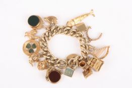 A large curb link 9ct gold charm bracelet with some 15ct charmsthe charms comprising a horn