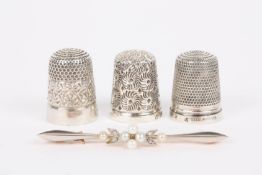 A 15ct gold, diamond and seed pearl bar broochtogether with three silver thimbles, one in a leather