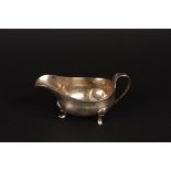 A George III silver sauce boat
hallmarked London 1797, of plain boat shaped form with scrolled