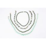 Three 20th Century Chinese green hardstone bead necklaces
together with another graduated