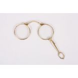 A late 19th century gilt metal lorgnette
with push button mechanism opening the lorgnette, with