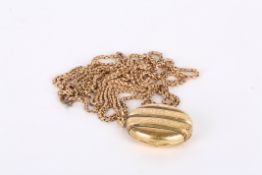 A late 19th century gold coloured metal oval triple photograph locketthe case with chased and twist