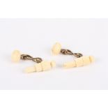 An unusual pair of Prisoner-of-war carved ivory cufflinks in the form of cannons
with brass links