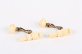 An unusual pair of Prisoner-of-war carved ivory cufflinks in the form of cannonswith brass links