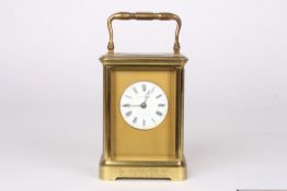 A late 19th century gilt brass carriage clock timepiecethe circular white enamel dial signed