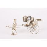 An early 20th century Chinese white metal novelty cruet set
in the form of a Rickshaw, being