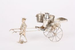 An early 20th century Chinese white metal novelty cruet setin the form of a Rickshaw, being