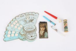 A small collection of sewing accessories comprising The Empire button sizing fan, a pin case and