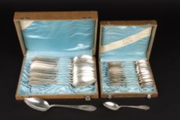 Two sets of Continental silver spoonsboth in fitted cases, comprising serving and tea spoons.,