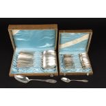 Two sets of Continental silver spoons
both in fitted cases, comprising serving and tea spoons.,