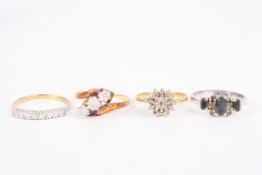 A group of four assorted ringscomprising a gold and diamond three stone ring, an 18ct gold and