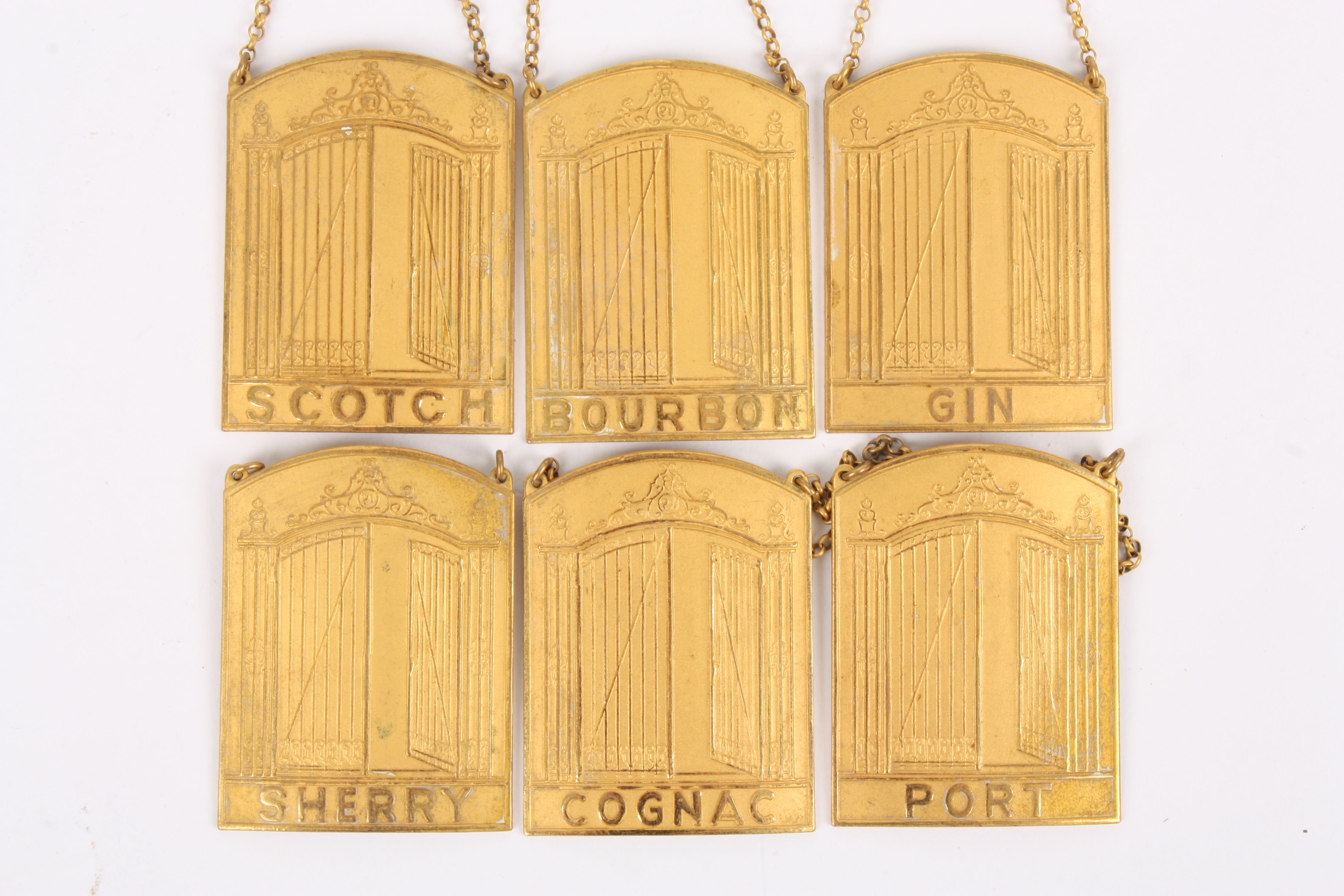 Six Sporrongs gilt metal decanter labels
the front of each arched label with embossed image of