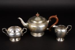 A George V silver three piece tea sethallmarked Birmingham 1924, comprising teapot, milk jug and