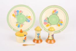 A Clarice Cliff Bizarre Crocus pattern three piece cruet setcomprising a salt, pepper and mustard