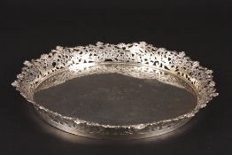 A mid 20th century silver plated circular traywith engraved inscription and pierced floral rim., 27
