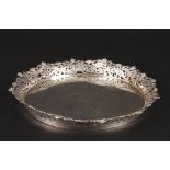 A mid 20th century silver plated circular tray
with engraved inscription and pierced floral rim., 27