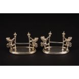 A pair of early 20th century Mappin & Webb silver plated knife rests
formed as rampant lions holding